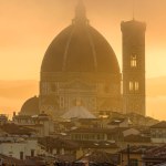 The Florence Cathedral in a golden misty sunrise early morning.
