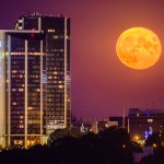 Prague, Czechia, August 2022 - A super moon rising next to hotel Corinthia