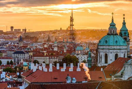 The Prague cityscape shortly after sunrise. St. Nicholas Church in the foreground and Zizkov TV tower in background.