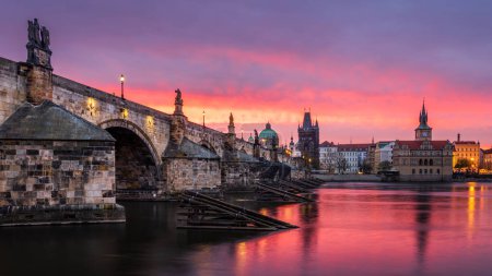 A pink and red dawn at the Charles Bridge in Prague.