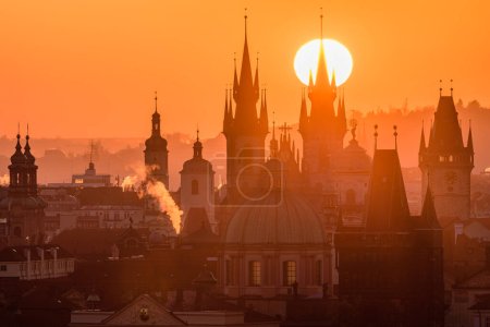 The rising sun above the Prague's cityscape.