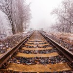 Railroad leading into the mist in a freezing day in winter in Krusne Hory, Czechia.
