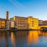 The Ponte Santa Trinita bridge over the Arno river in Florence enlighten by a strong sunlight in the morning.