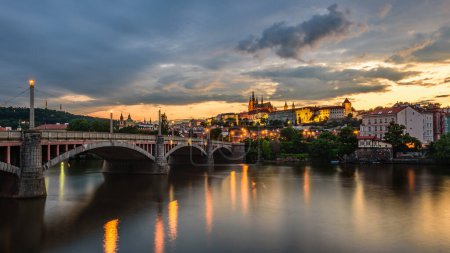Foto de Castillo de Praga y Manesuv la mayoría (puente de Manes) sobre el río Moldava en Praga al atardecer. - Imagen libre de derechos