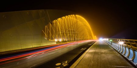 A night view of the Troja Bridge (Trojsky most) with the light trail of cars in Prague, Czech republic.