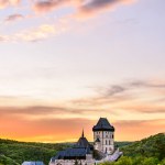 An orange twilight after sunset above the famous castle Karlstejn in Czech republic.