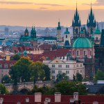 The cityscape of Prague listed in Unesco with Church of Our Lady before Tyn and Charles Bridge in the dawn. 