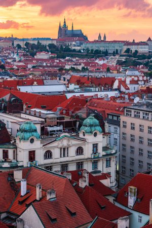 The aerial Prague cityscape of downtown and the castle and the St. Vitus Cathedral in sunset.