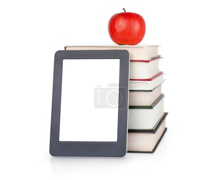 Foto de E-book near the stack of hardcover books with apple on the top isoalted on white. Concepto educativo - Imagen libre de derechos