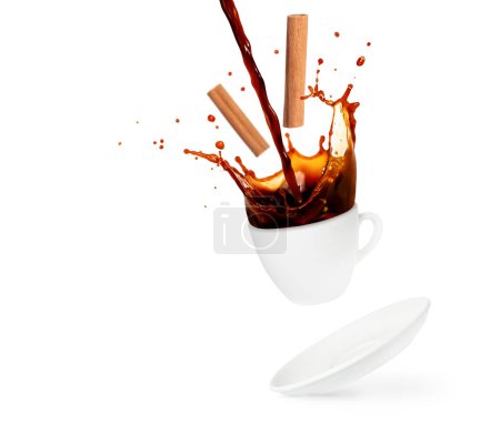 Pouring and splashing coffee with cinnamon sticks isolated on white background