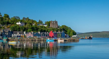 The town of Tobermory, Isle of Mull, Scotland. Beautiful brightly coloured shops and homes on the seafront.  Famous for the children's television show Balamory.  Busy with lots of visitors on holiday to the island on vacation in the sunshine