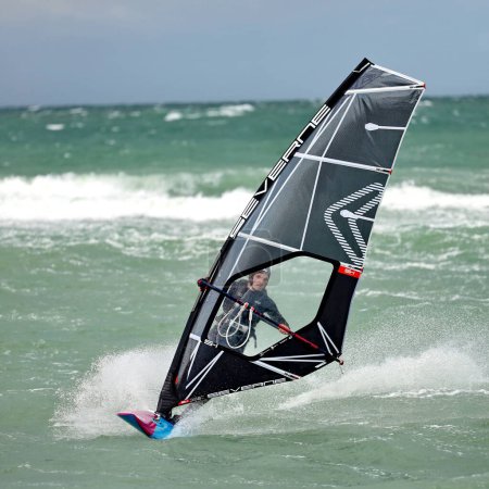 Photo for Windsurfer at Raageleje Beach on a windy day in July - Royalty Free Image