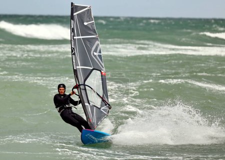 Photo for Windsurfer at Raageleje Beach on a windy day in July - Royalty Free Image