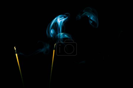 Téléchargez les photos : La fumée d'encens crée une variété de formes de motifs sur un fond noir mise au point sélective faible profondeur de la photographie de terrain - en image libre de droit