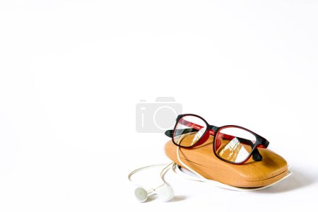 Photo for Specs, specs box and earphones on white background blurred the shallow depth of field - Royalty Free Image