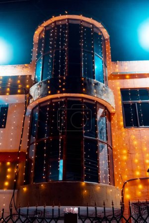 Foto de Foto nocturna de una parte de un edificio decorado con luces de cuerda para una boda - Imagen libre de derechos