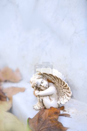 Photo for A closeup shot of a beautiful white angel with a crown on a stone - Royalty Free Image