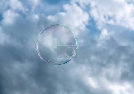 Flying soap bubbles in front of the sky