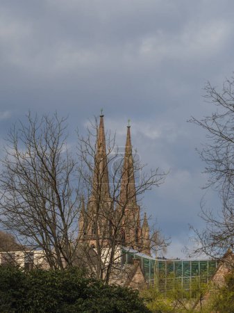 Towers of the Elisabeth Church with the university's glass building