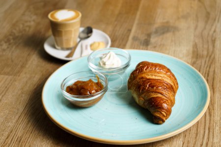 Photo for Croissant with jam, cream and a cup of coffee - Royalty Free Image