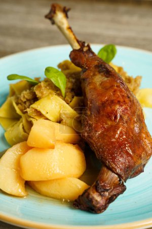 Roasted goose leg with cabbage papardelle pasta and quince compote