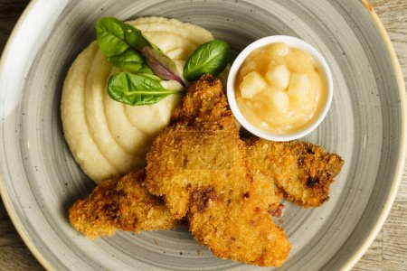 Fried fish with mashed potatoes and quince apple jam