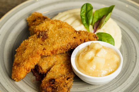 Fried fish with mashed potatoes and quince apple jam