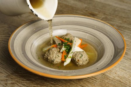Goose soup, consomme with dumplings and vegetables