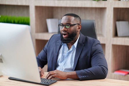 Photo for African American Businessman looks puzzled and shocked checking emails showing disappointment. - Royalty Free Image