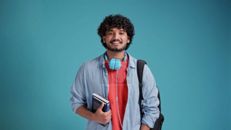 indian male student portrait on blue background