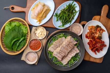 Photo for Korean food, bossam, boiled pork, pig feet, steamed pork feet, side dishes, lettuce, garlic bossam, perilla leaves, chives, kimchi, food, meat, meal, dinner, pork, chicken, plate, rice, dish, cuisine - Royalty Free Image