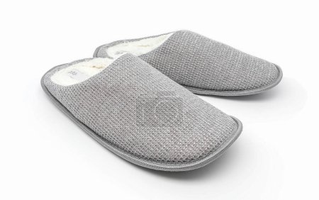 Foto de Zapatillas de casa grises aisladas sobre fondo blanco. Una cálida sandalia doméstica. Zapatos de cama calzado accesorio. - Imagen libre de derechos