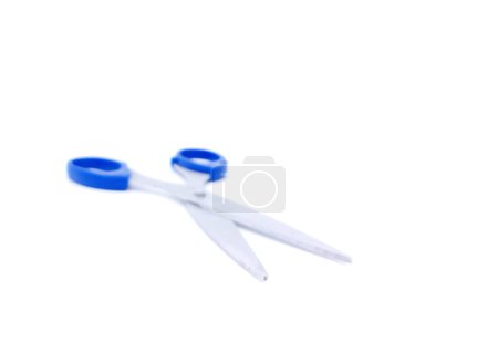Photo for Scissors with blue handle, isolated on white background with copy space. Shallow depth of field. Side view. - Royalty Free Image