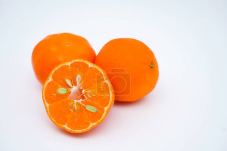 Photo for Cut and whole fresh ripe oranges isolated on white background with copy space. Close-up view. - Royalty Free Image