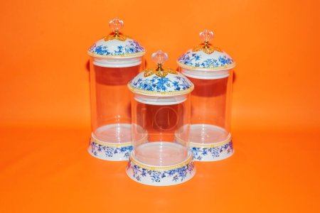 Photo for The Set of Three Glass Jars with Blue Flower Pattern White Lids offers a perfect storage solution for your kitchen or pantry. - Royalty Free Image