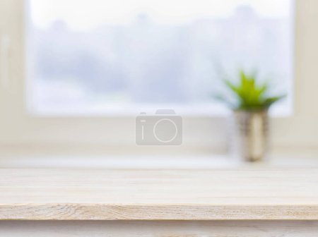 Photo for Wooden table on defocused winter window background. Copy Space. - Royalty Free Image