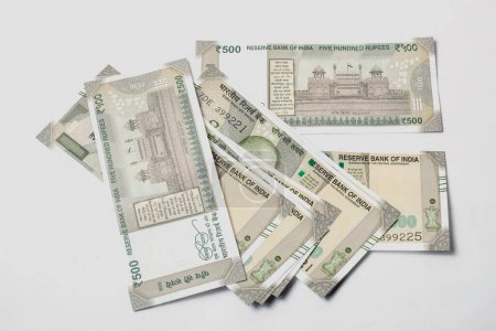 500 hundred rupees Indian money isolated on white background. Pile of Indian money five hundred rupee banknotes.