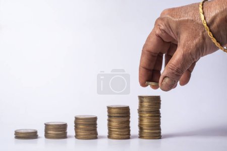 Indian woman stacks coins on white background. business ideas and financial growth concept.