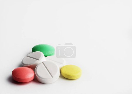 Photo for Round tablets on a white background. A pile of small round medicines close up. Healthcare and medicine concept. - Royalty Free Image