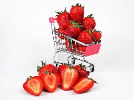 Foto de Fresas en el carrito de la compra, aislado sobre fondo blanco. Comprar fruta en el supermercado. - Imagen libre de derechos