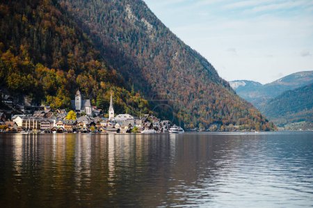 Foto de Vista panorámica del otoño del famoso pueblo de montaña Hallstatt en la región de Salzkammergut, Austria. Cielo nublado azul y gran lago. Hermosa y acogedora ciudad - Imagen libre de derechos
