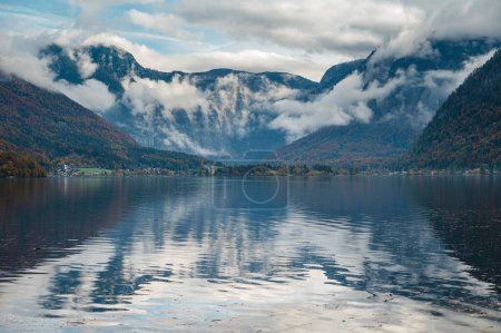 Photo for Panorama view of Hallstattersee mountain in daylight with snow and cloudy sky. Landscape view of famous Hallstatt lakeside town during winter. Salzkammergut region, Austria - Royalty Free Image