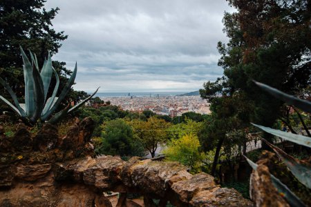 Foto de Fascinating view on magnificent city to blue sea from Guell park in Barcelona. Nature and urban compatibility concept. - Imagen libre de derechos
