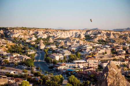 Photo for Top view of beautiful small town in Turkey surrounded with rocky mountains. Air Balloons flying in Cappadocia region. Concept of adventure and travelling. - Royalty Free Image