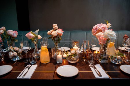 Photo for Cozy table setting for wedding or another catered event dinner with warm candles lights - Royalty Free Image