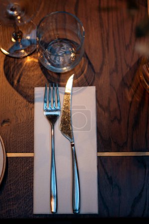 Téléchargez les photos : Table mise au restaurant. Fourchette et couteau sur la table en bois avec serviette. - en image libre de droit