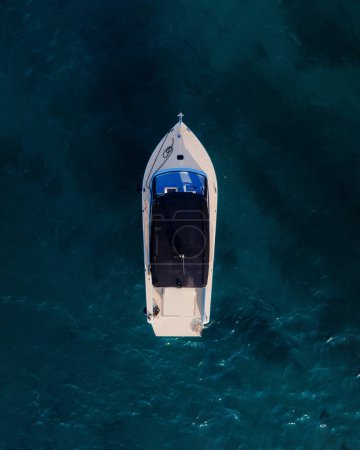 Photo for Aerial symmetrical photo with boat centered in blue sea water. Drone shoot - Royalty Free Image