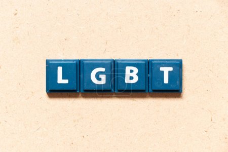Photo for Tile letter in english word LGBT (Abbreviation of lesbian, gay, bisexual, and transgender) on wood background - Royalty Free Image