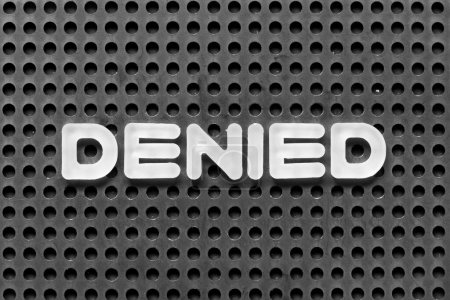 Photo for White alphabet letter in word denied on black pegboard background - Royalty Free Image