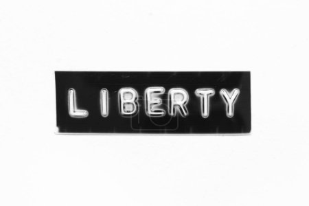 Photo for Black color banner that have embossed letter with word liberty on white paper background - Royalty Free Image